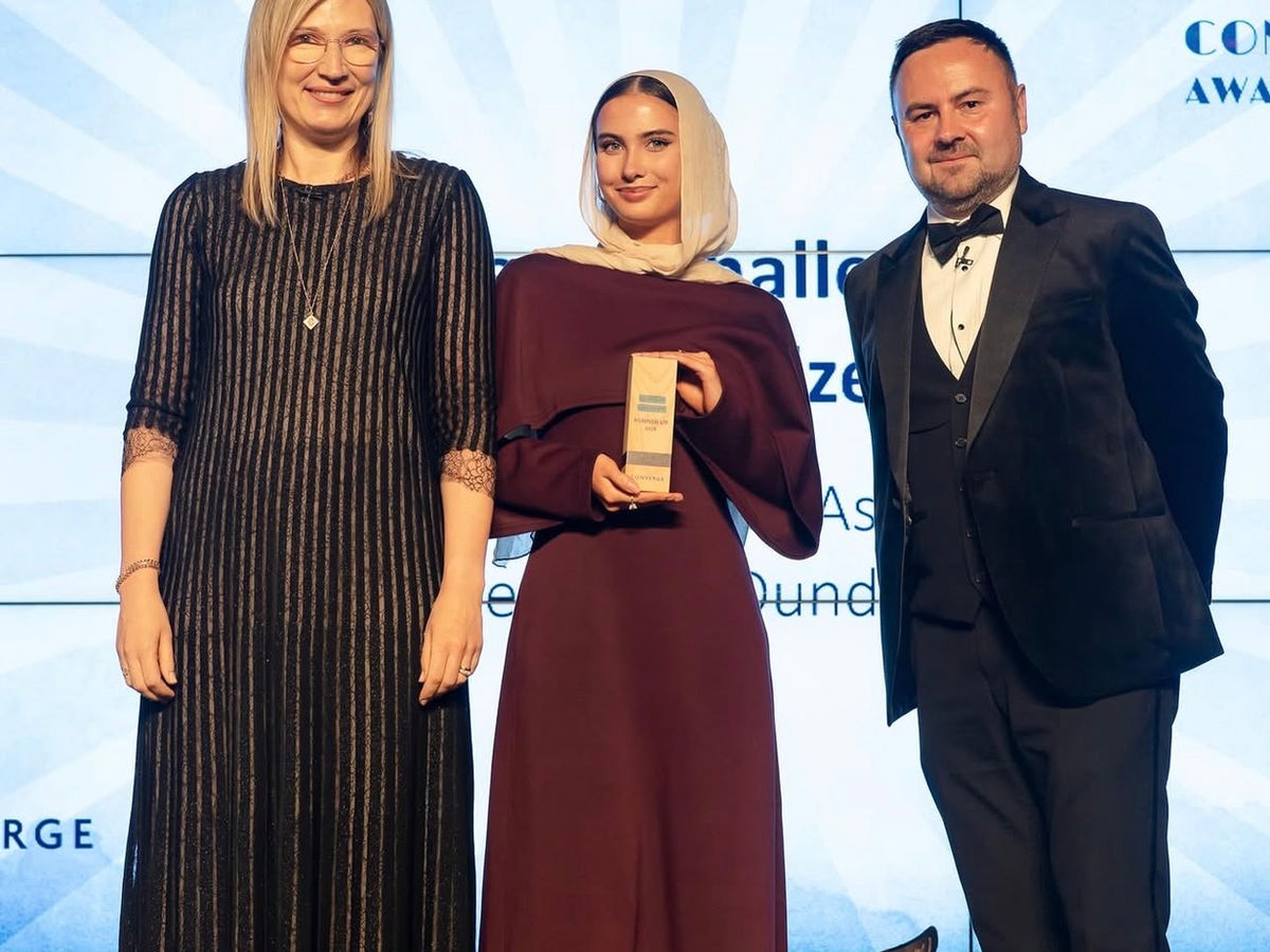 Hana Woods receiving a Converge award on behalf of MedAscend